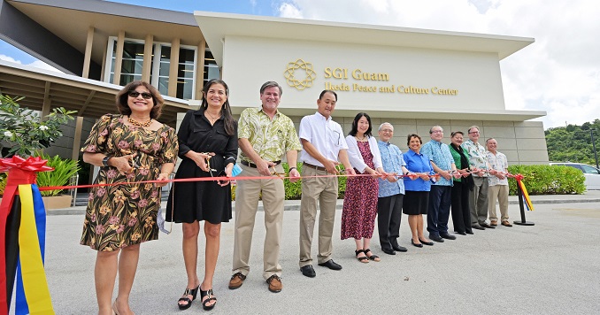 People standing in a line for the ribbon cutting ceremony.