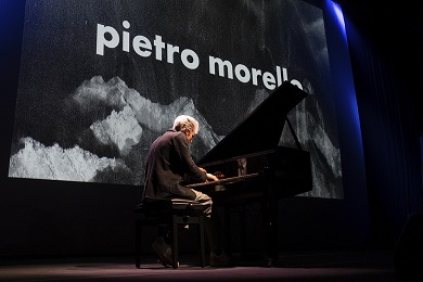 A man playing piano on stage