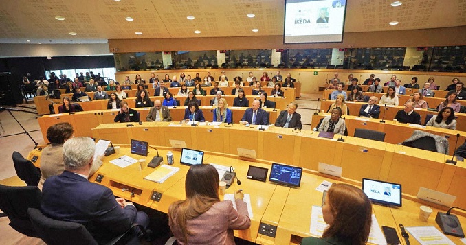 Speakers and guests in a conference room.