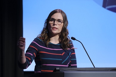 A woman at a podium giving a speech. 