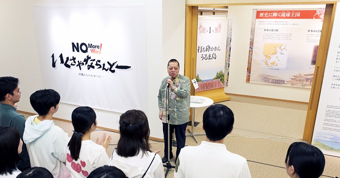 A person giving a speech at the opening ceremony of an exhibition.