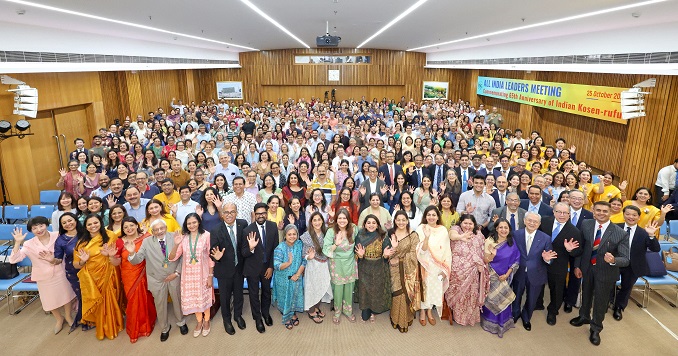 People standing for a commemorative photograph in a large hall.
