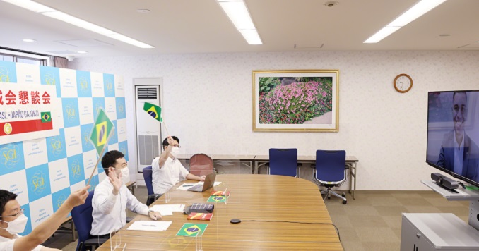 A small group of young men at a table waving flags