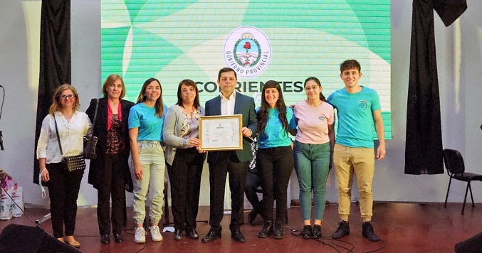 People standing on a stage holding an award